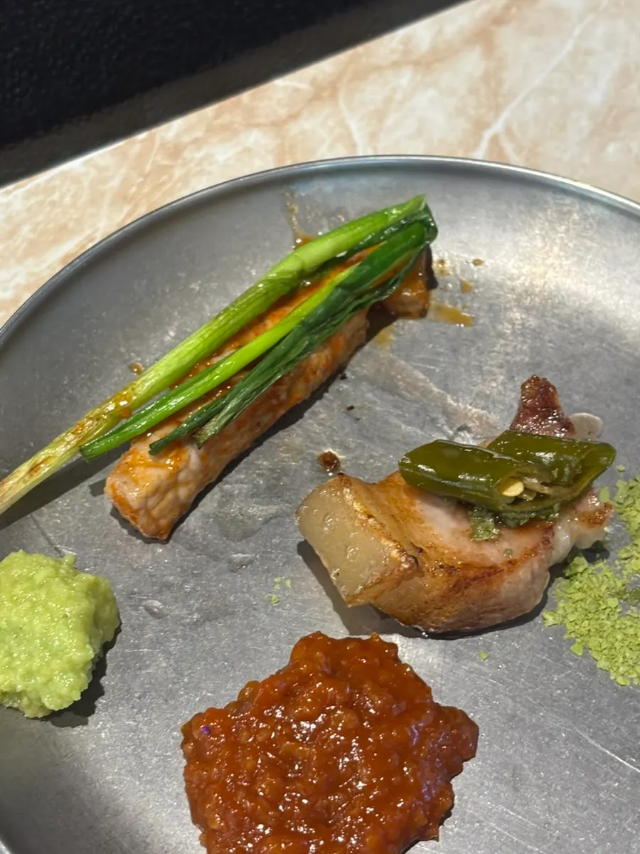 Black pork dipped in mel jorim with grilled scallions