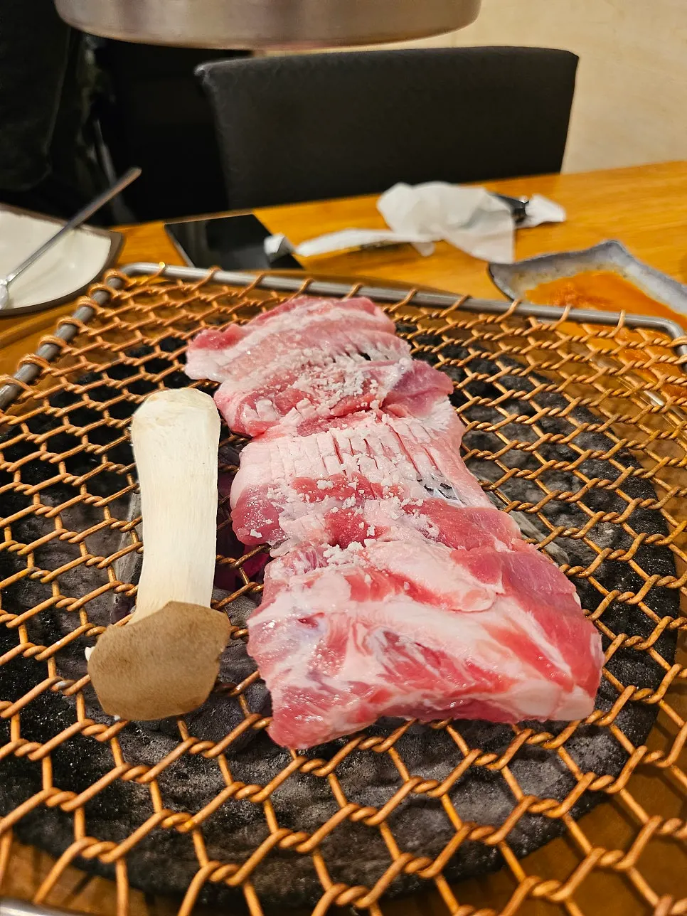 Fresh ribs grilling over charcoal