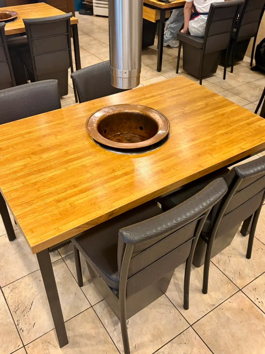 Vertical photo of a table with a charcoal grill