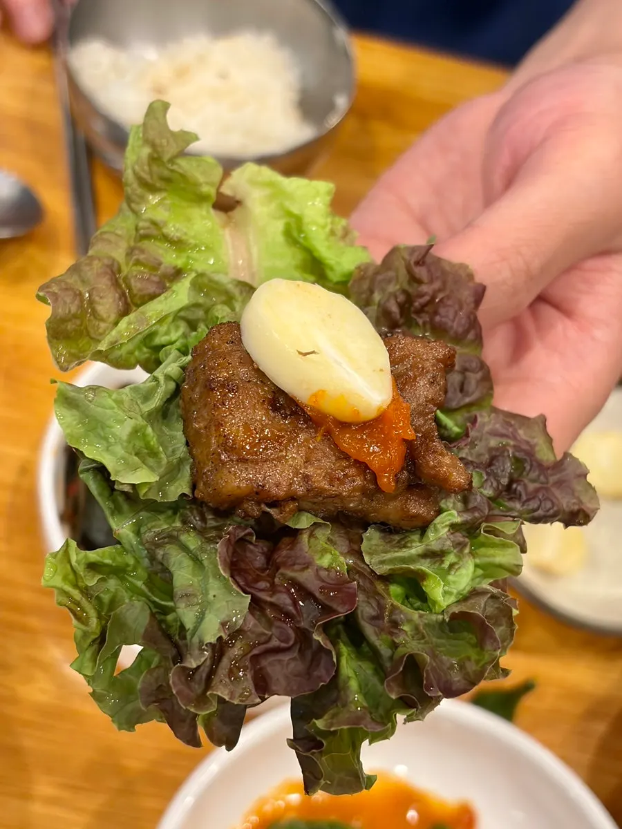 A piece of seasoned rib placed on pickled onions