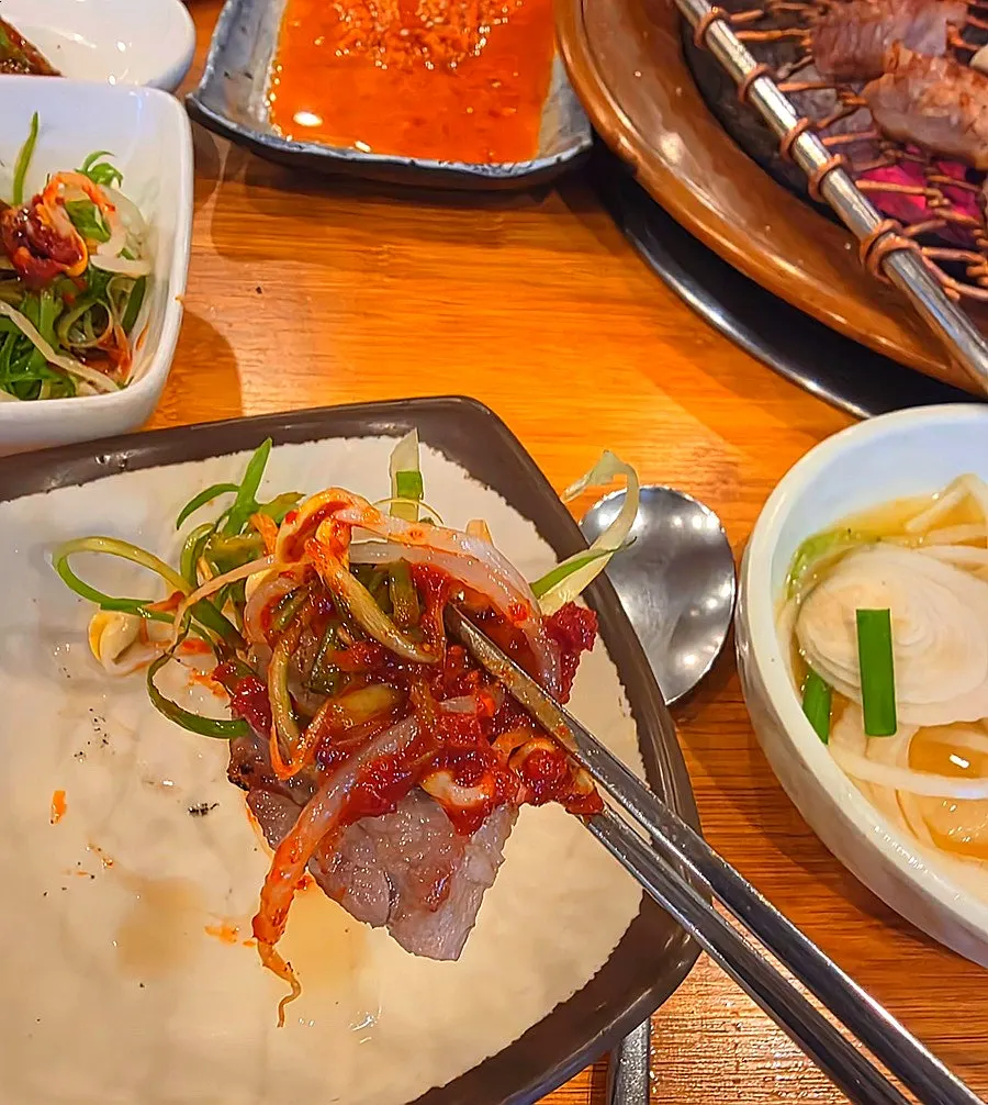 Dinner table with charcoal-grilled meat and wrap vegetables