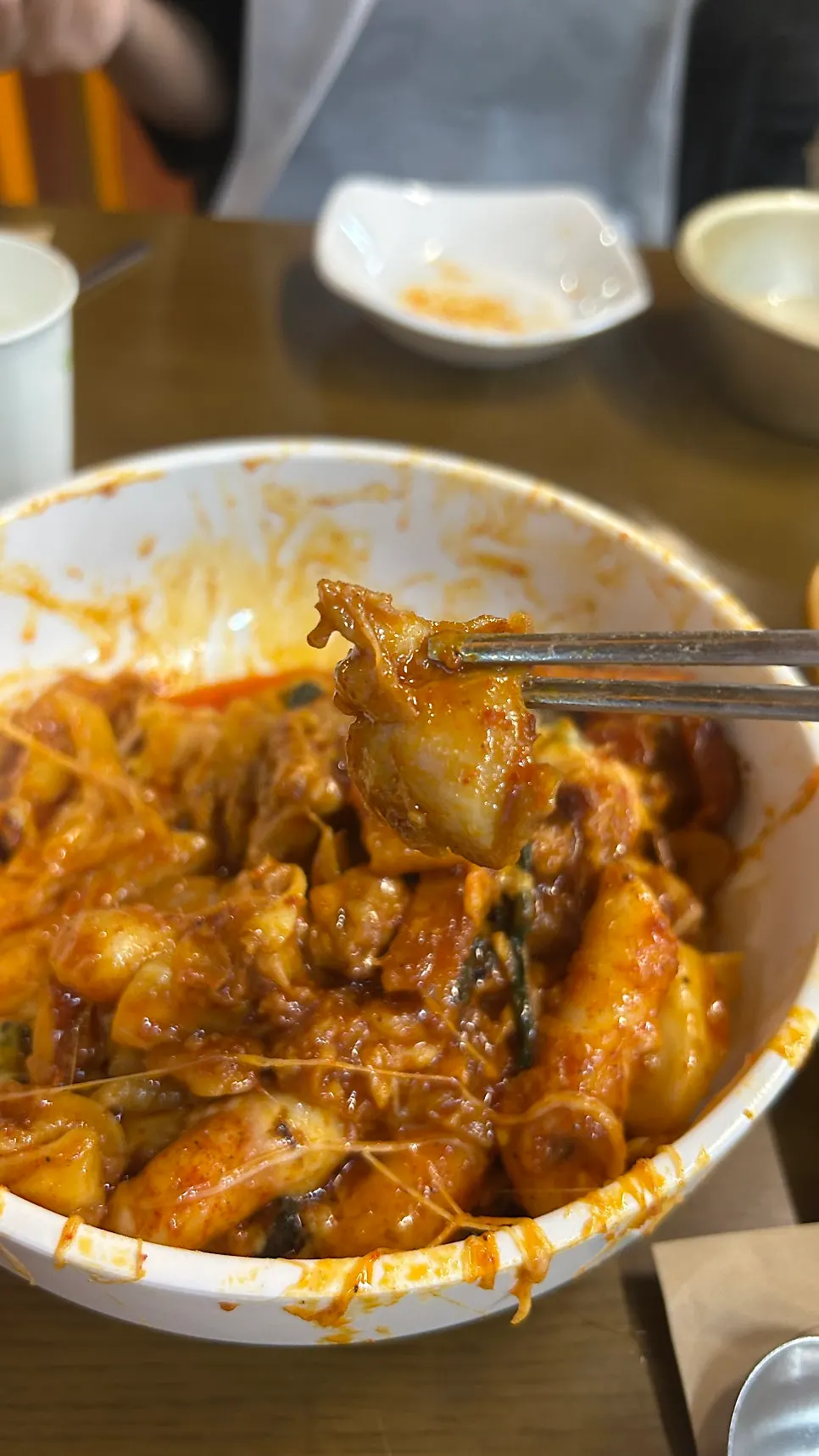 Scooping fully cooked lid-pot dakgalbi with a large ladle