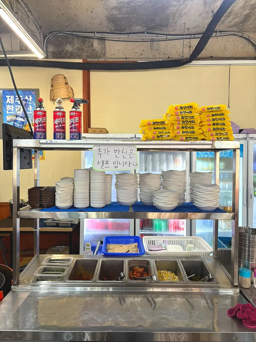 Unlimited lunch ramyeon noodles piled up at the self-serve side dish corner