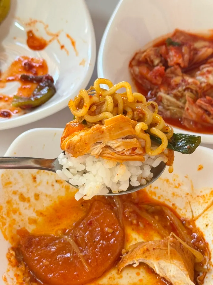 Ramyeon noodles lifted out of the pot
