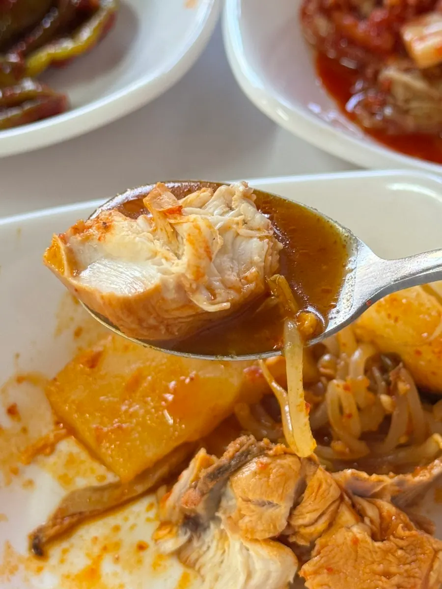 A piece of Korean beef tripe dripping with oil
