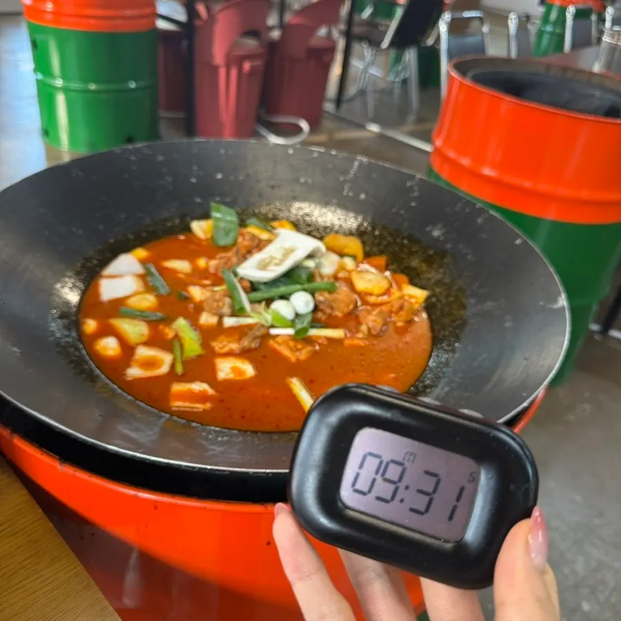 Iron lid piled high with raw dakdoritang ingredients