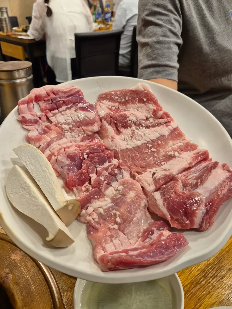Two servings of raw galbi sprinkled with salt
