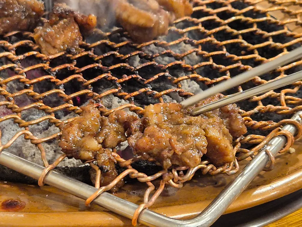 Marinated pork ribs grilling on charcoal