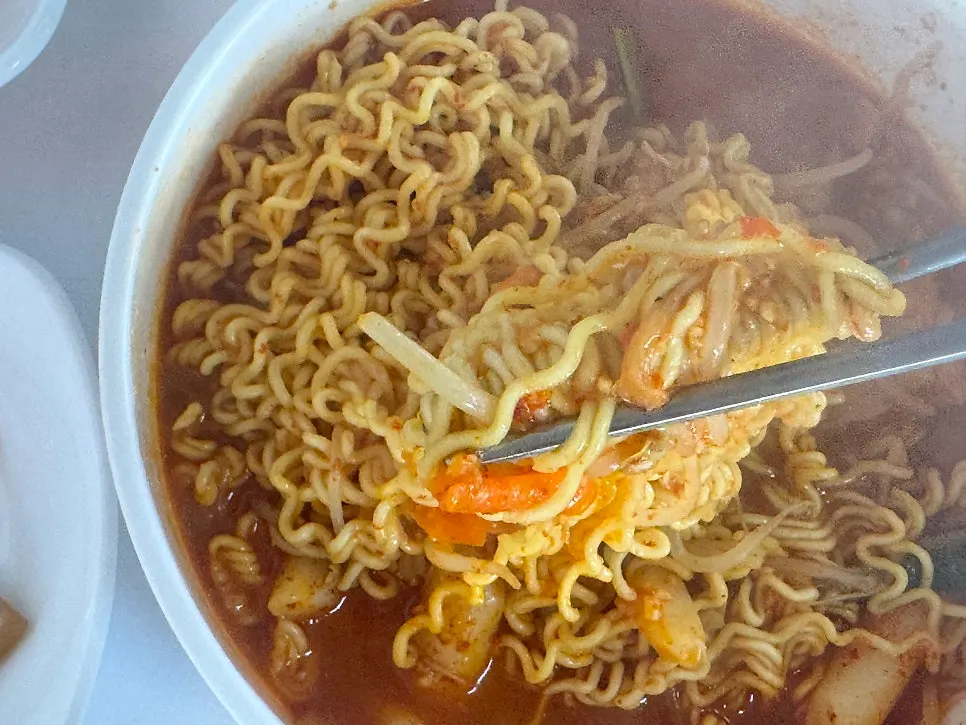 Ramen noodles cooking in the broth