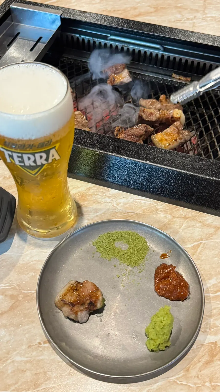 Side dish and matcha salt plate setting at Pork80