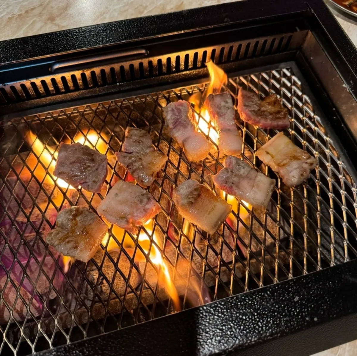 A full spread of black pork BBQ at Pork80 Jeju Airport Branch