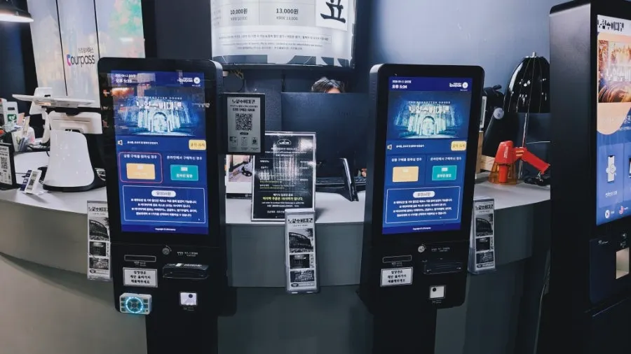 Black-and-white lobby with the ticket-printing kiosk