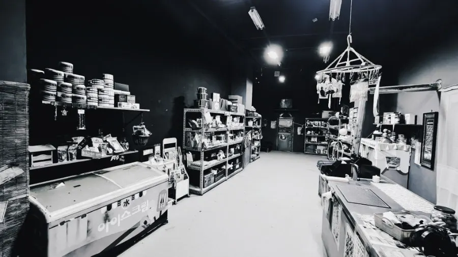 Items displayed inside the supermarket, all styled in black and white