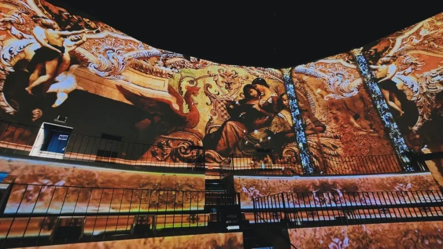 Large main hall with video unfolding across walls and floor