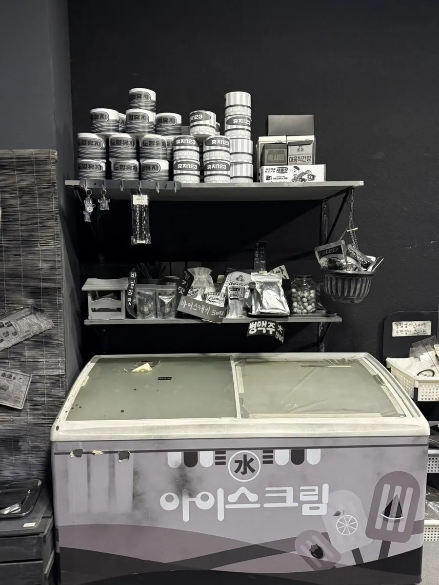Black-and-white exhibit space seen from the 2nd floor stairs at Nohyeong Supermarket
