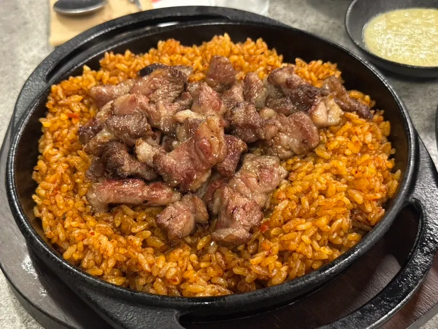 Signature kkakdugi fried rice topped with bone meat