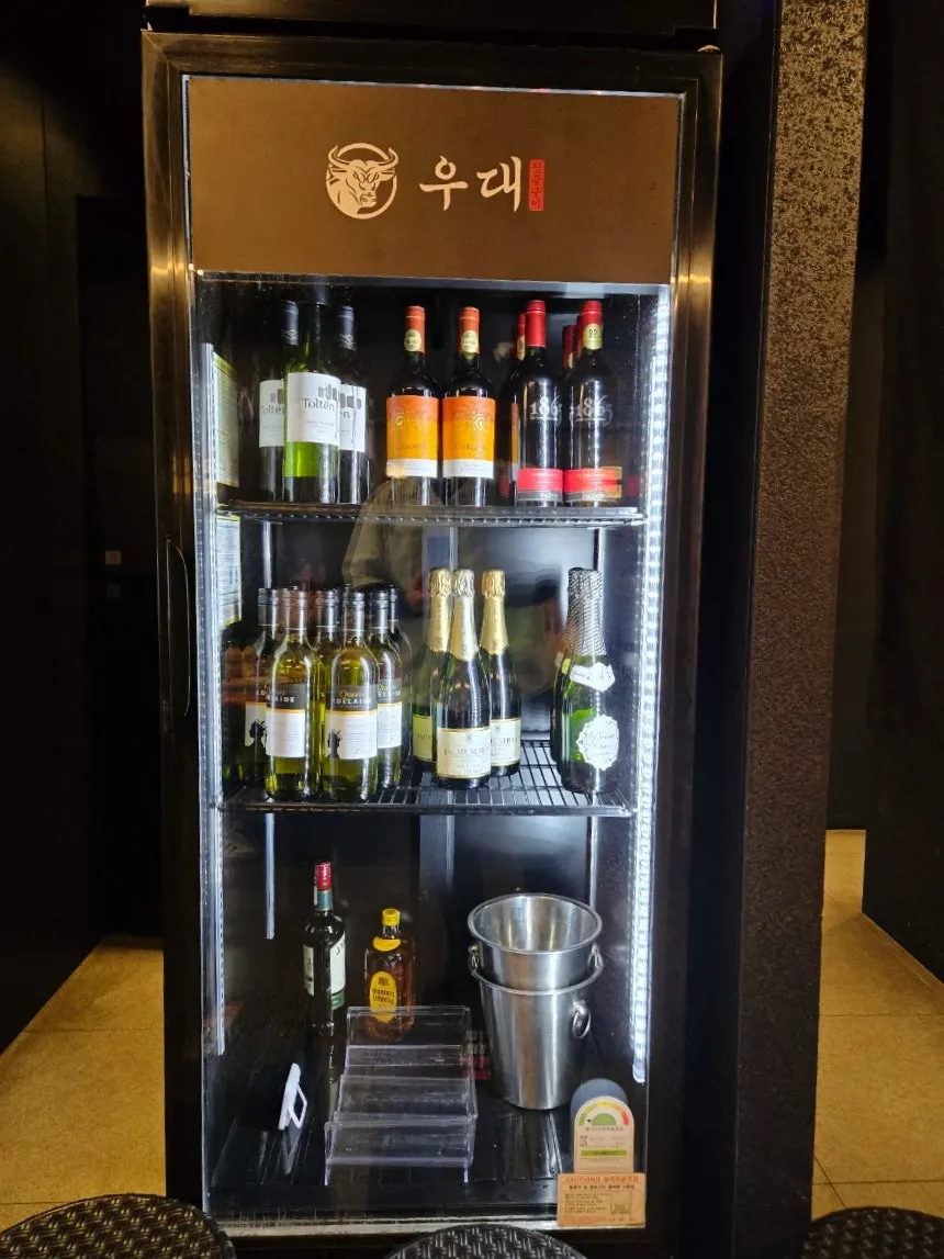 Staff member grilling udae galbi tableside