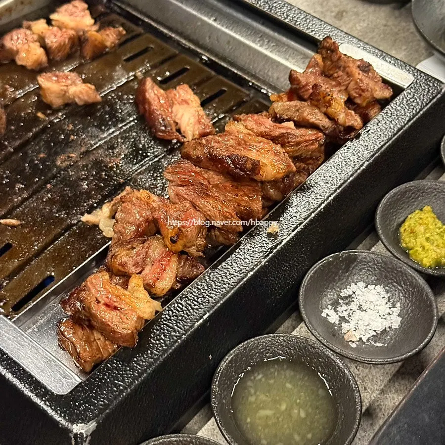 A piece of udae galbi dipped in Maldon salt