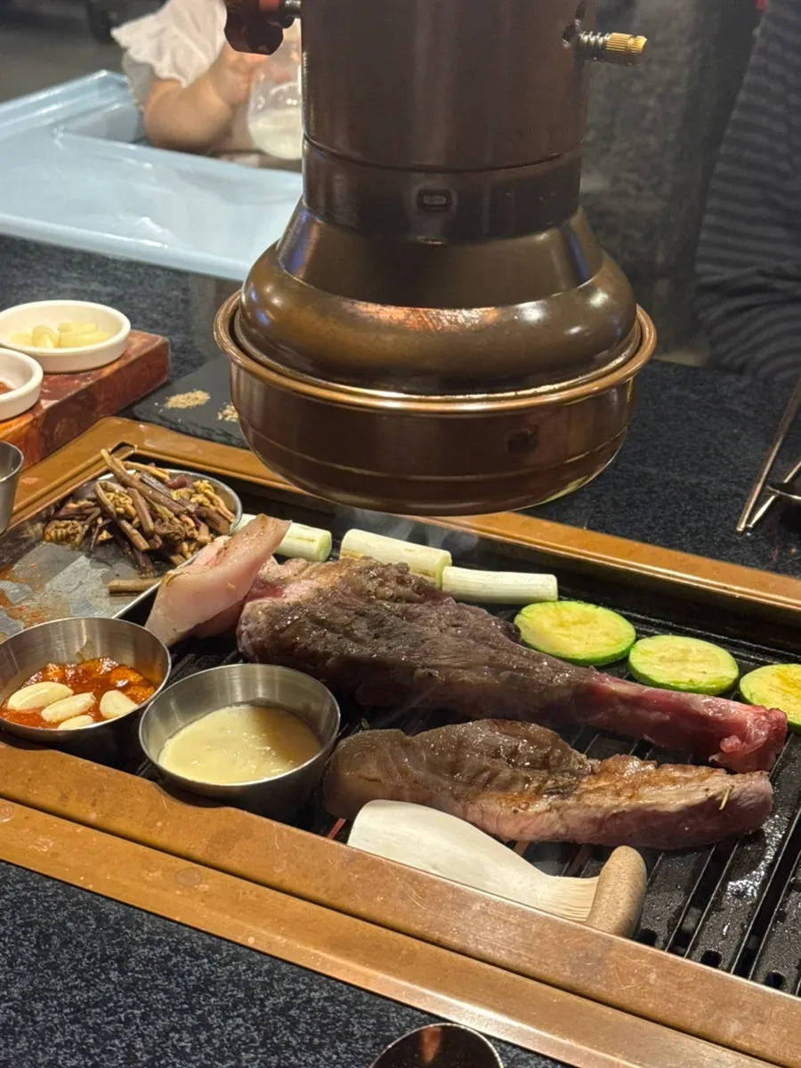 Staff grilling Jeju black pork shoulder rack