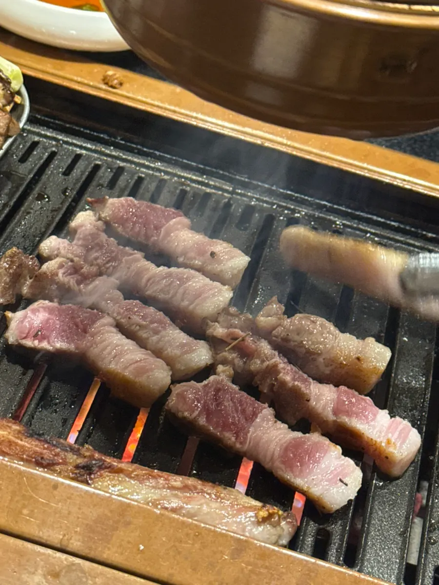 336-hour aged black pork belly on the grill