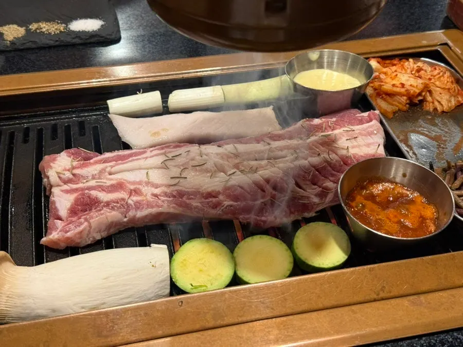 Staff member oiling the grill plate