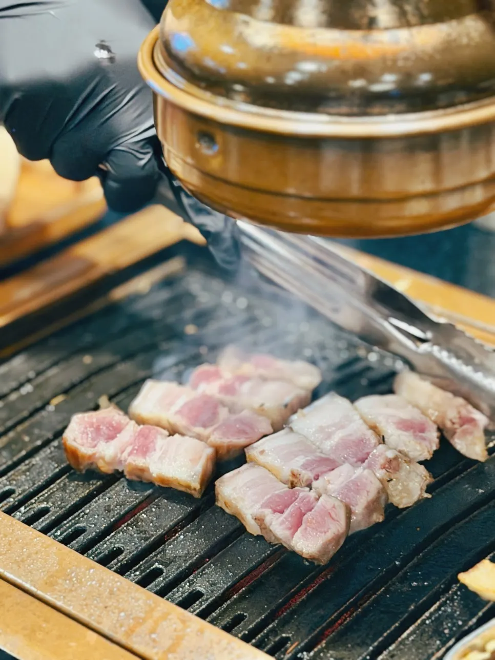 Thick black pork belly grilling on the pan