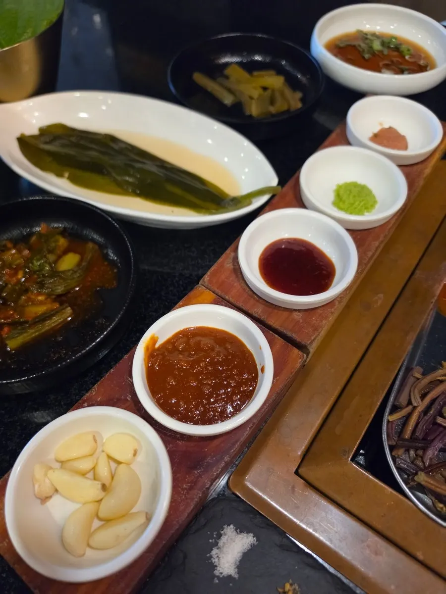 Sauces and seasonings including pink salt on the table