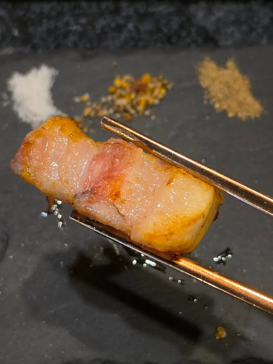 A bite-sized piece of grilled black pork