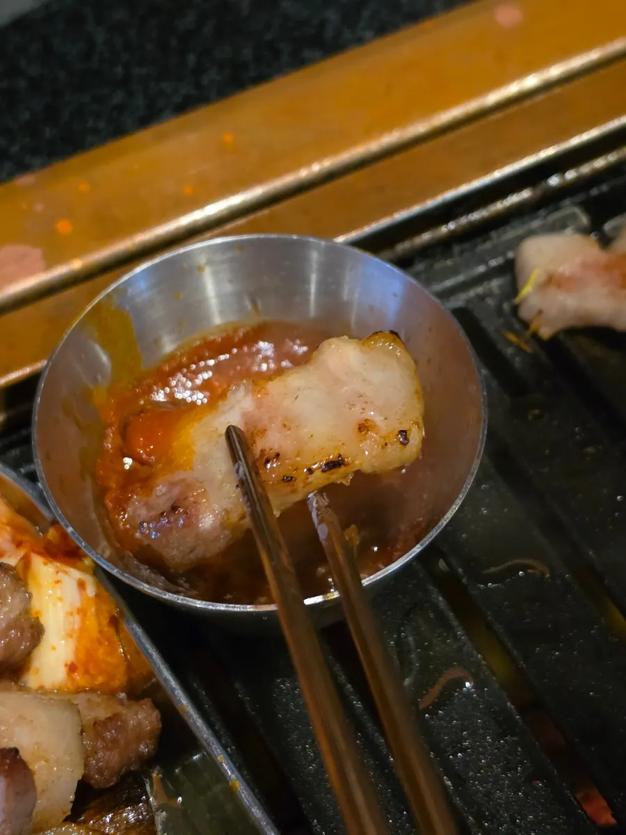 Black pork dipped in myeoljeot sauce