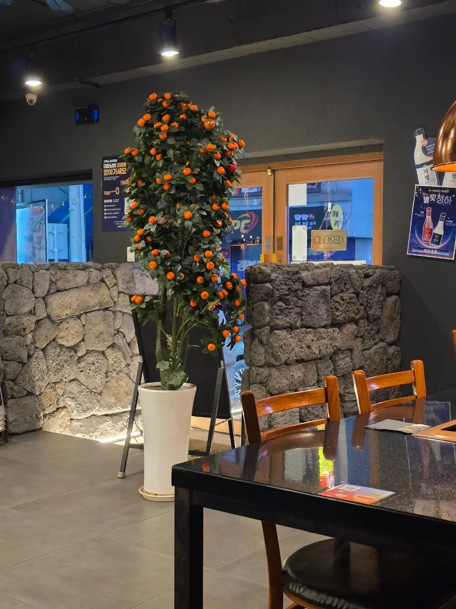 Jeju Oktop interior decorated with stone walls and dol hareubang statues