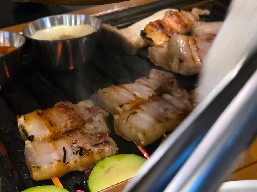 Black pork belly grilling with the skin left on