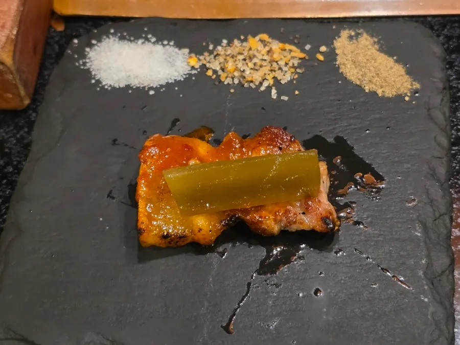 A piece of black pork placed on a wrapping leaf