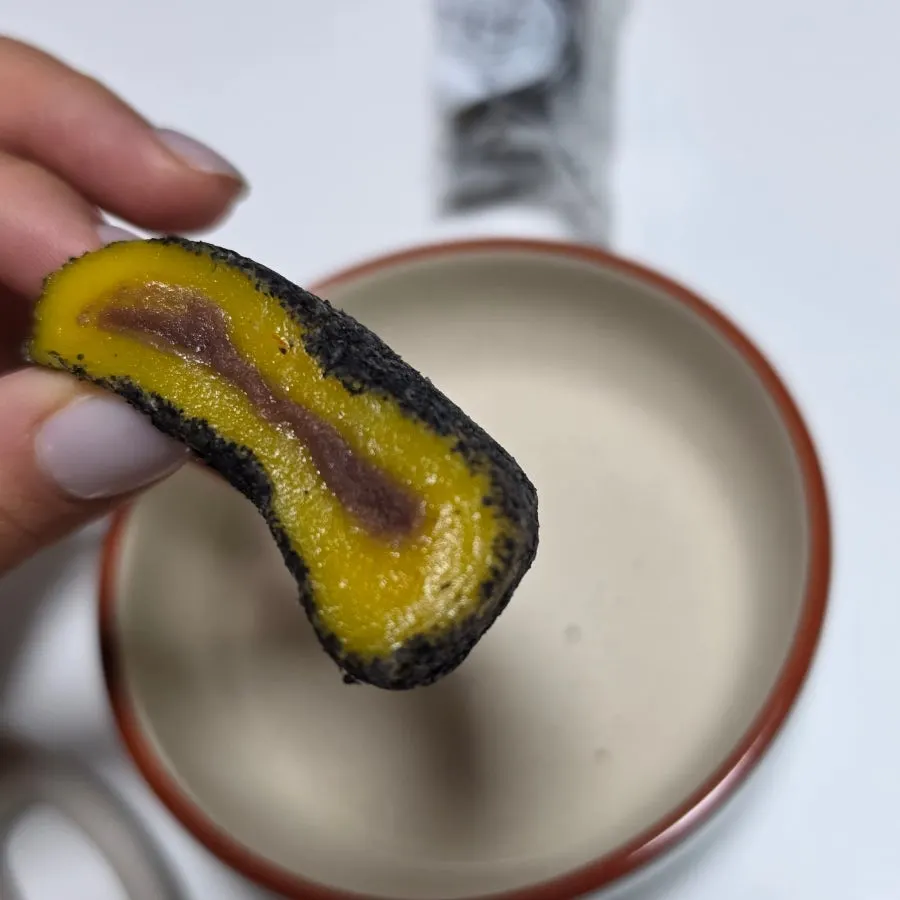 Omegi-tteok thickly coated in black sesame powder