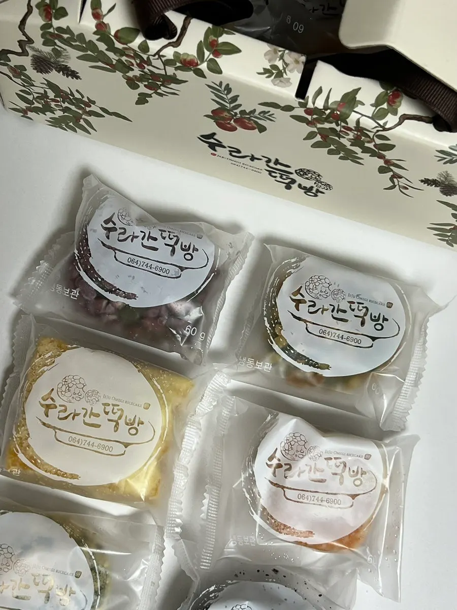 A piece of omegi-tteok generously coated in red bean