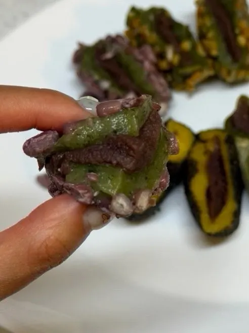 A chewy omegi-tteok held in hand
