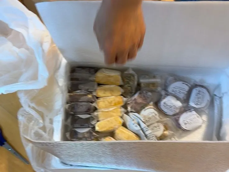 Opening a box of rice cakes received by courier