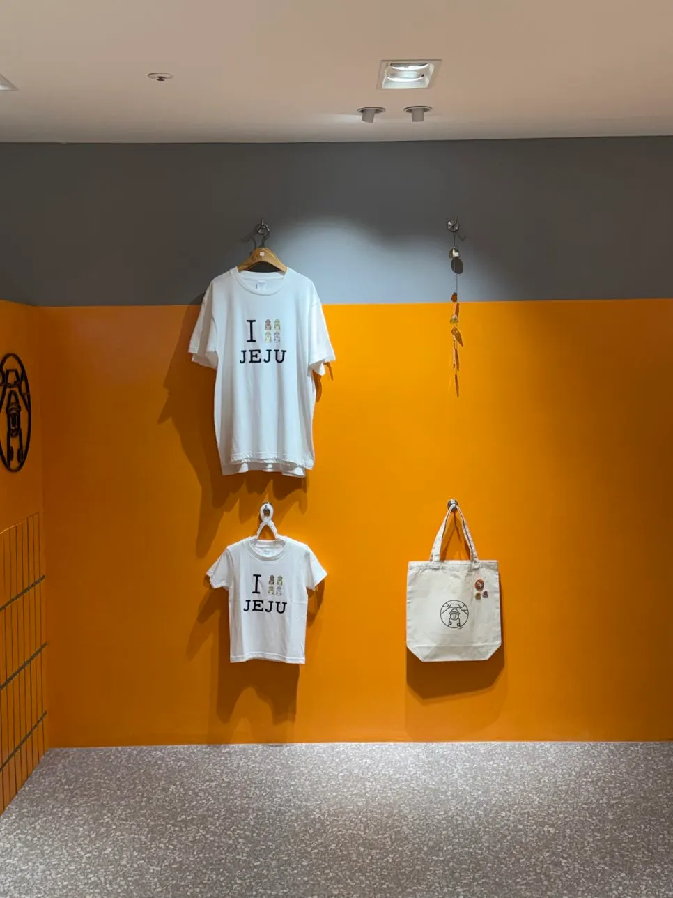 T-shirts and bags displayed at Today Jeju