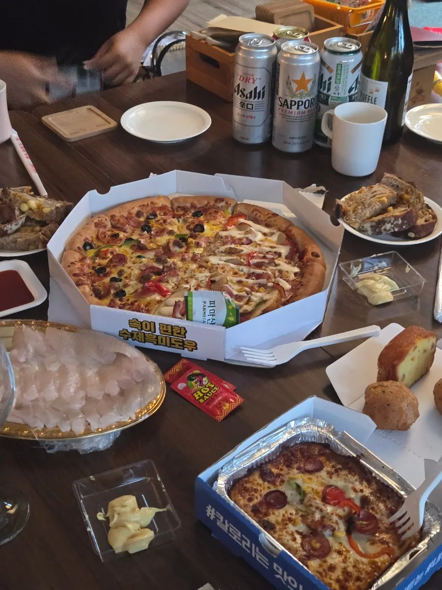 Pizza brought to a guesthouse potluck party