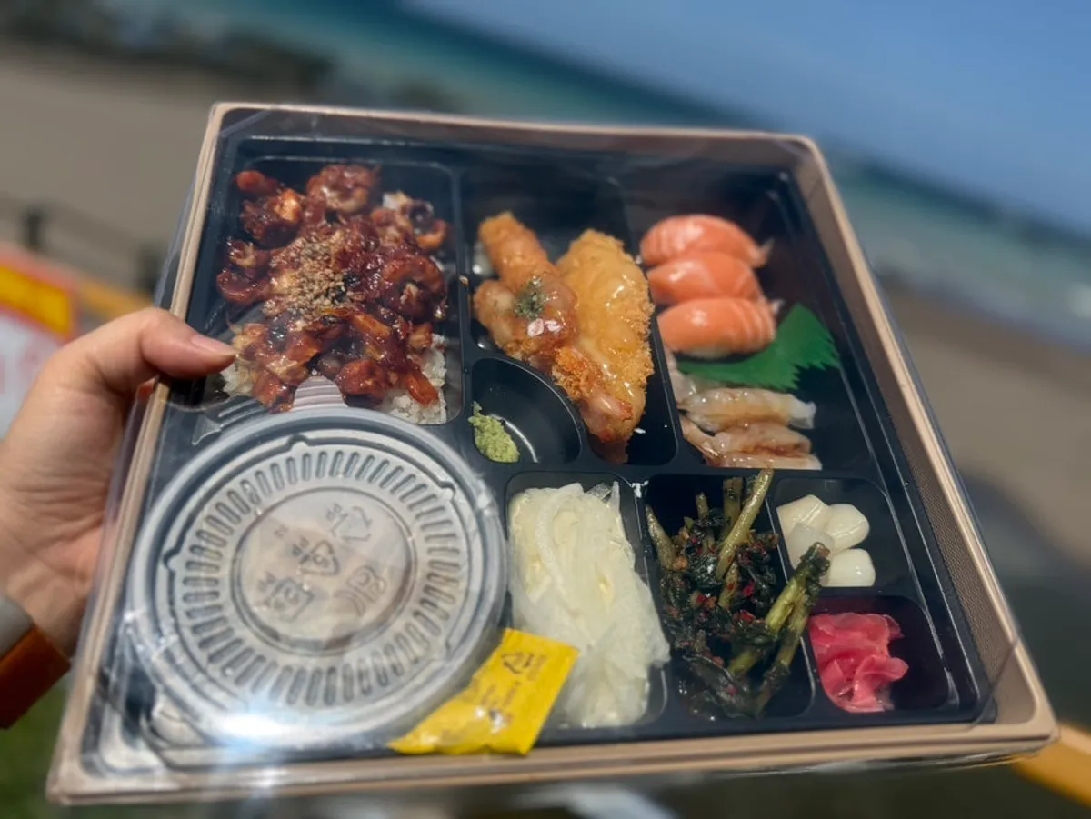 Takeaway lunch box in front of the sea at Samyang Beach