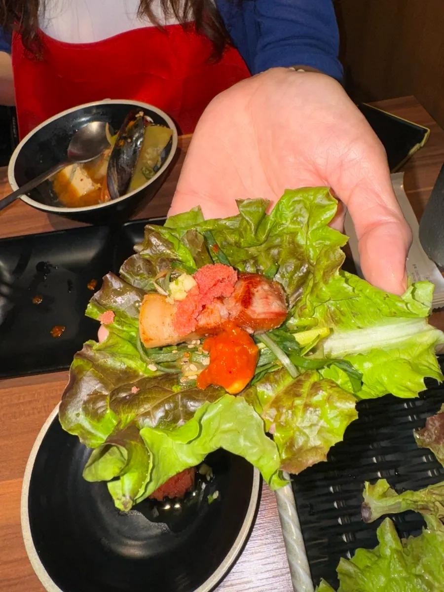 A piece of black pork belly dipped in salt