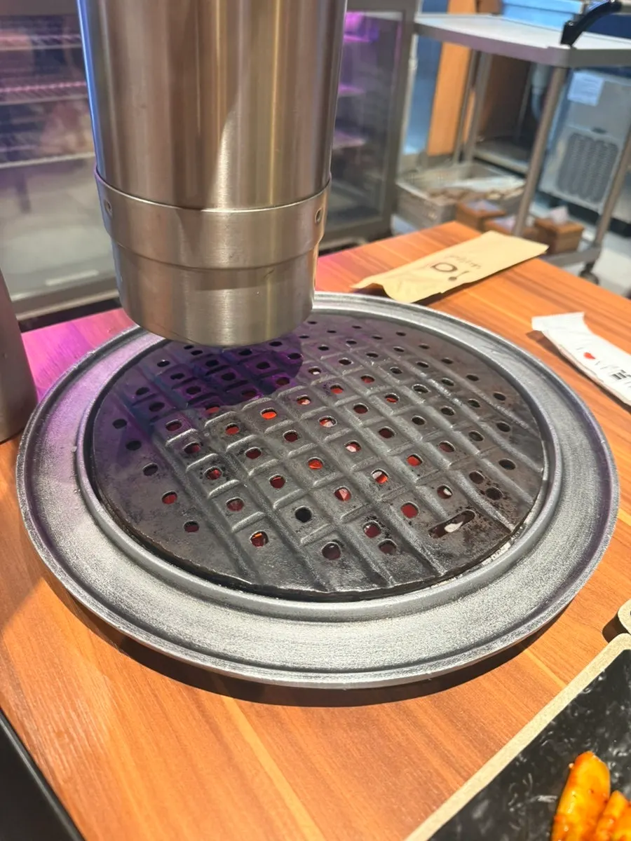 Cast-iron plate set over the charcoal