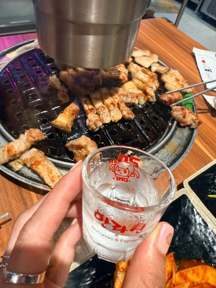 Bottle of Hallasan Original finished alongside the black pork