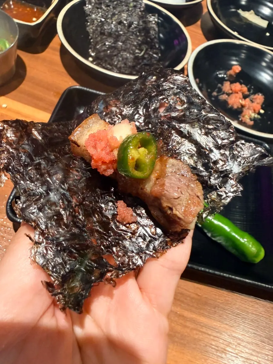 A bite of black pork paired with gim