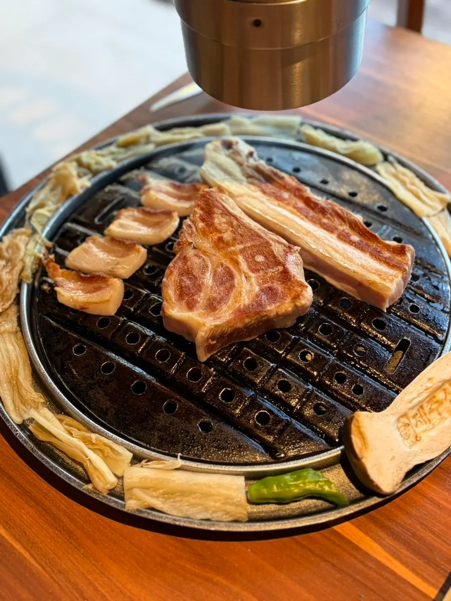 Thick black pork cooking on the grill