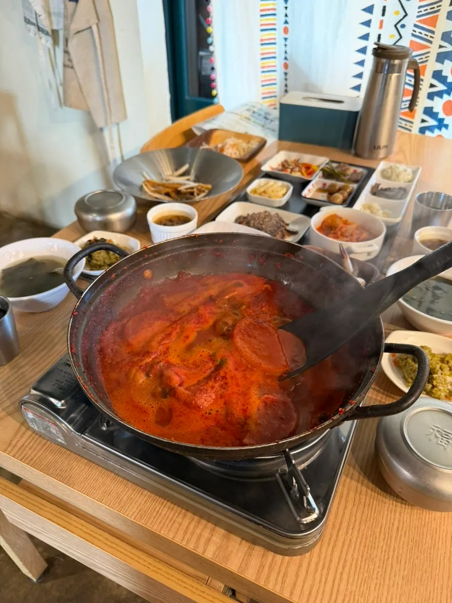 Pot of boneless cutlassfish stew with red sauce and radish