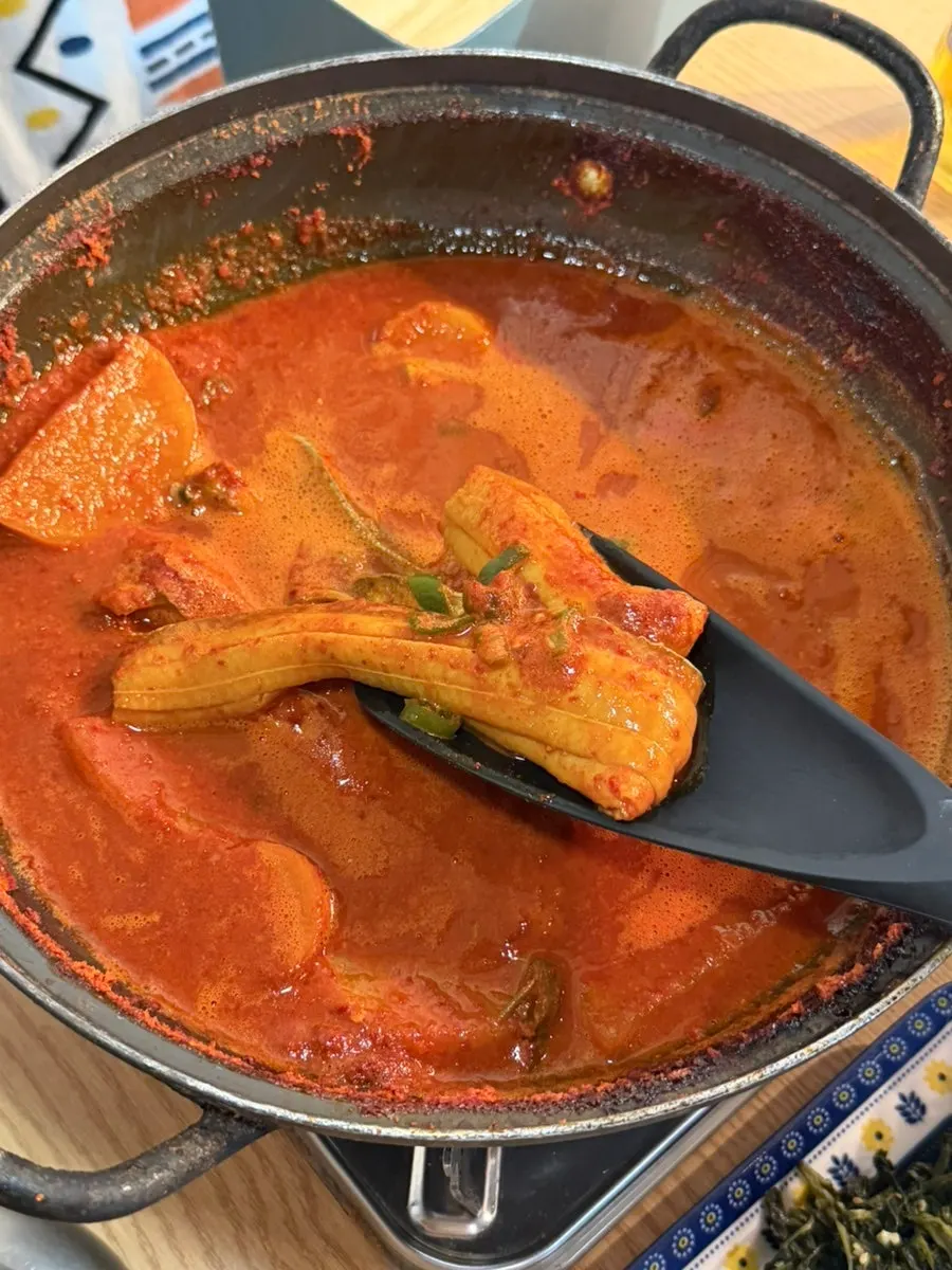 A large piece of boneless cutlassfish lifted up