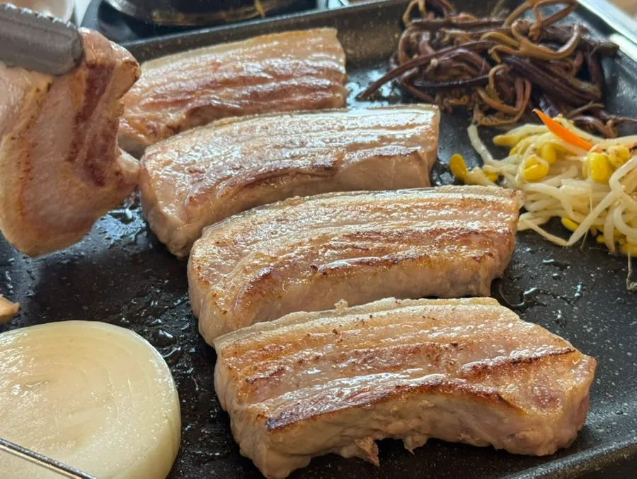 Black pork belly turning golden brown