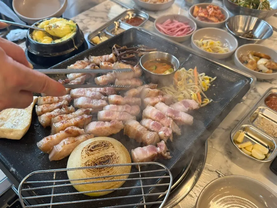 Table with black pork kimchi jjigae and rice