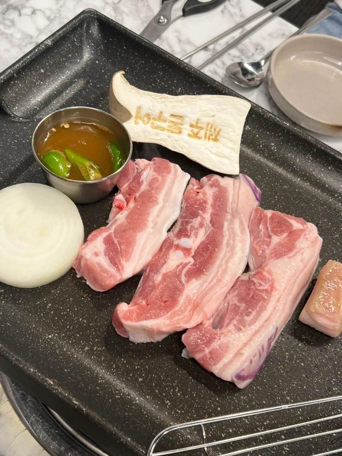 Raw aged black pork belly, two servings
