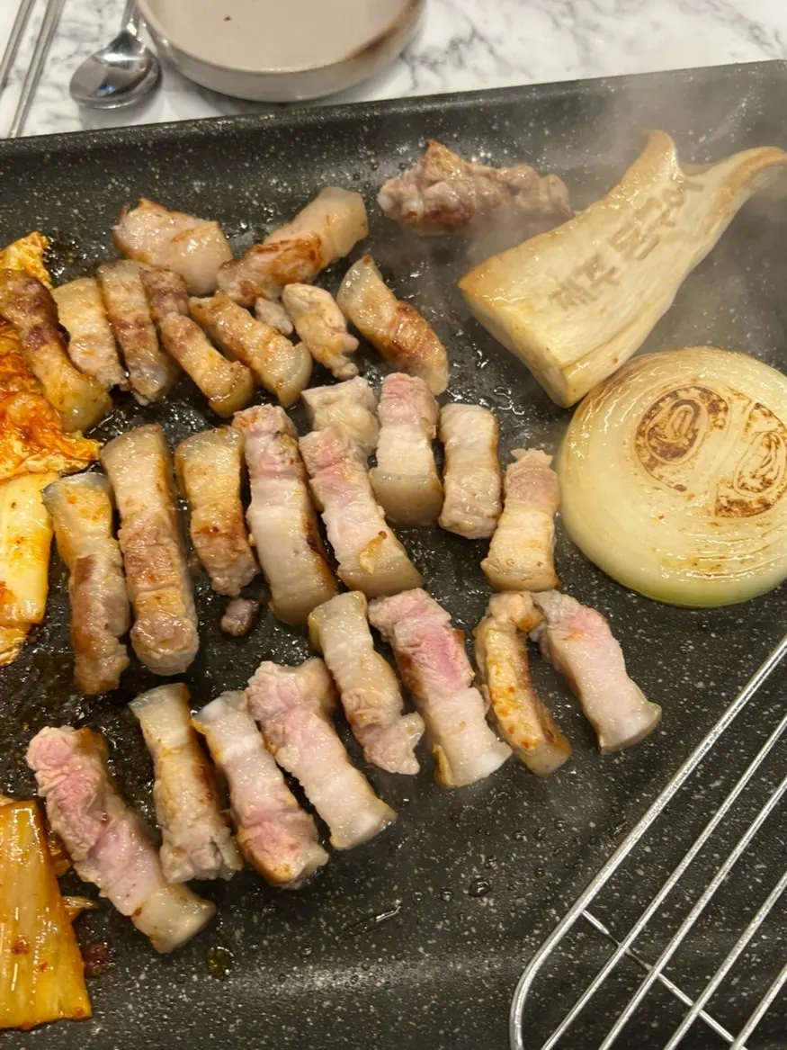 Kimchi and bean sprouts cooking in the meat fat